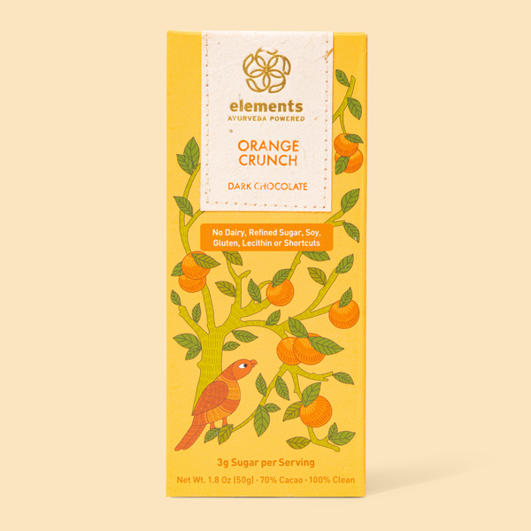 Packaging of Elements brand Orange Crunch dark chocolate bar with illustrations of oranges and a bird, highlighting 3 sugar per serving and 70% dark chocolate content.