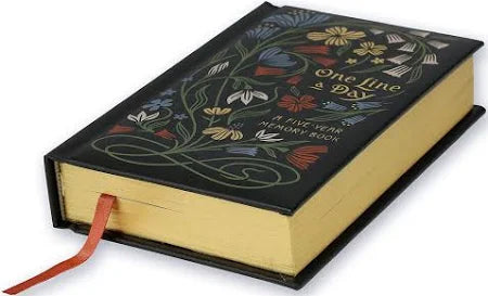 Decorative book with floral designs and a ribbon on a white background
