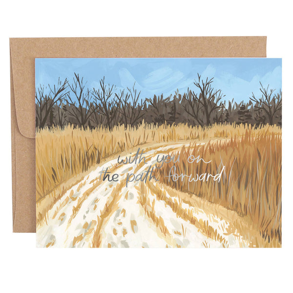 A greeting card featuring a painting of a dirt path with tall grasses on either side, leading towards a line of trees in the background. The sky is mostly clear with a few clouds, and there's a note of encouragement written on the path.