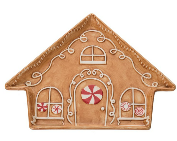 A ceramic gingerbread house-shaped plate with decorative details such as peppermint swirls and frosted windows.