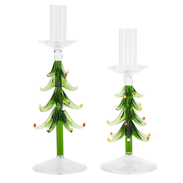 A pair of glass tree taper holders with green, red, and yellow patterns designed to resemble Christmas trees, with clear candle holders on top.