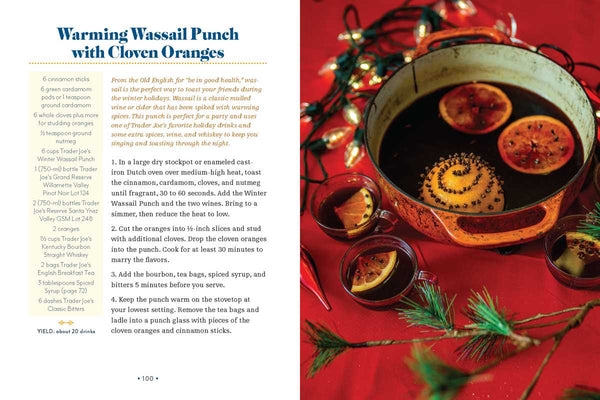 Warming Wassail Punch with Cloven Oranges on a red background with Christmas lights.