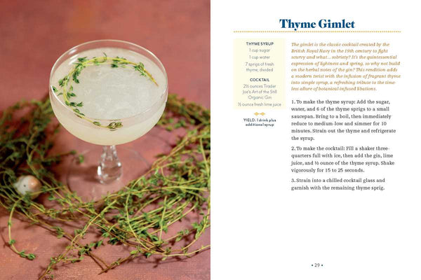 Cocktail glass with a Thyme Gimlet on a pink background with thyme sprigs.