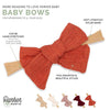 Orange baby bow with features and Parker Baby Co branding on a white background