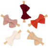 Set of five fabric bows with wooden clips on a white background