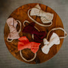 Set of colorful bow-shaped headbands on a wooden surface