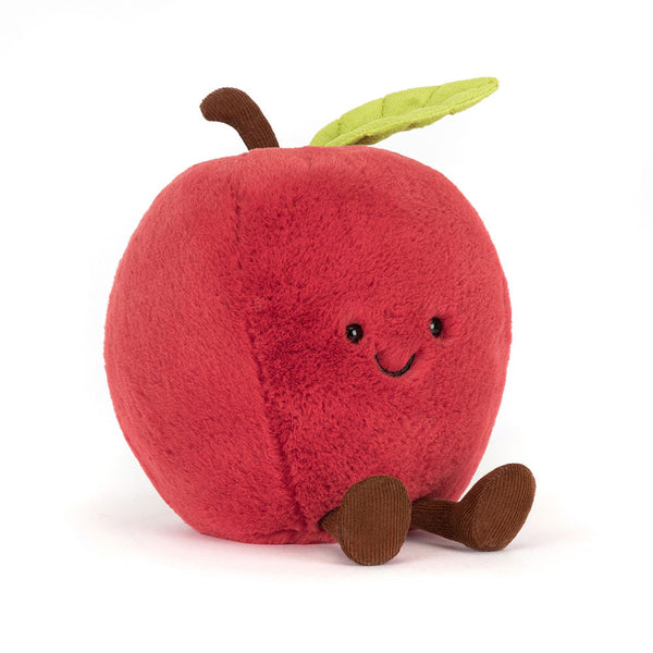 Plush toy shaped like a red apple with a smiling face on a white background