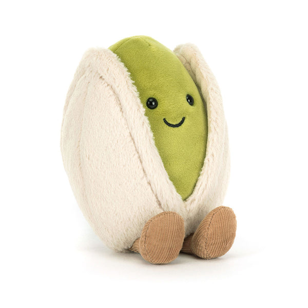 Plush toy in the shape of a pistachio with a smiling face on a white background