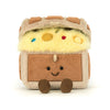 Plush toy resembling a camper van with a smiling face on a white background