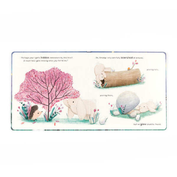 Illustrated children's book page with animals and a pink tree.