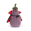 A plush toy resembling an eggplant with a vampire theme, featuring a purple body, green leafy crown, and a black-and-red collared cape tied with a cord.