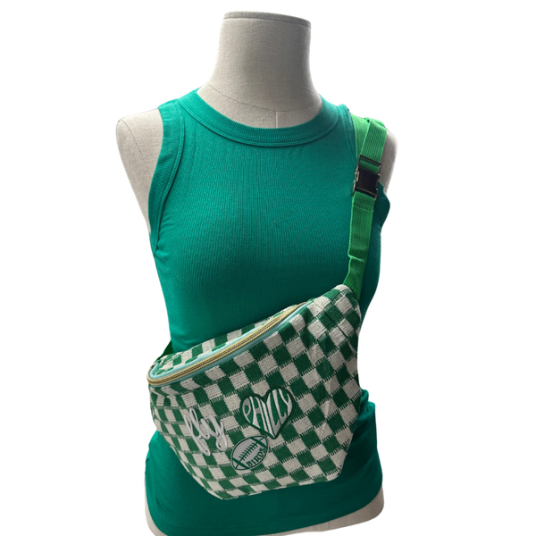 Green checkered bag with a brand logo on a mannequin wearing a green shirt.