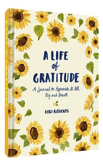 A cover image of 'A Life of Gratitude' journal by Lori Roberts featuring a floral pattern with sunflowers and the title displayed prominently.