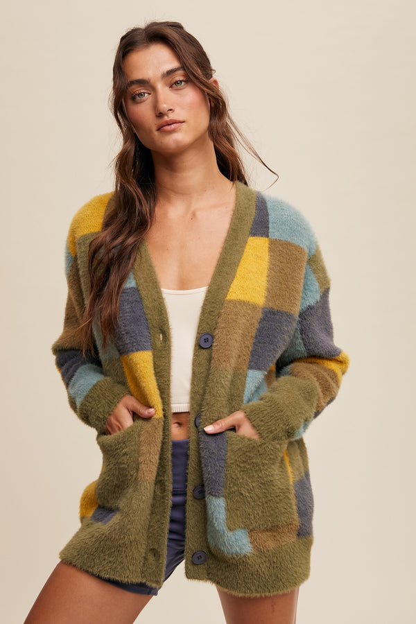 Woman wearing a colorful patterned cardigan on a beige background
