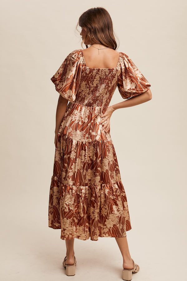 Woman wearing a patterned dress on a beige background