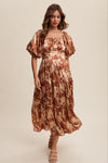Woman wearing a patterned dress on a beige background
