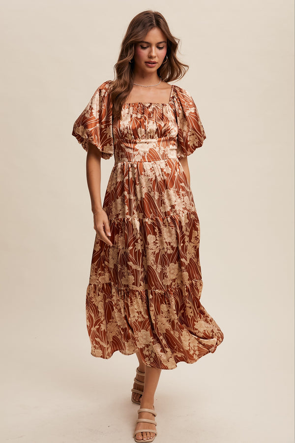 Woman wearing a patterned dress on a beige background