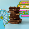 Stack of chocolate bars with a colorful candy store background