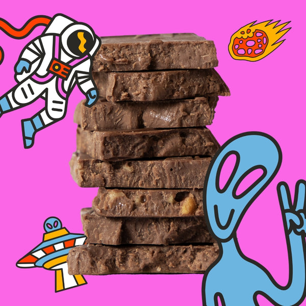 Stack of chocolate with colorful illustrations of an astronaut, alien, and rocket ship on a pink background