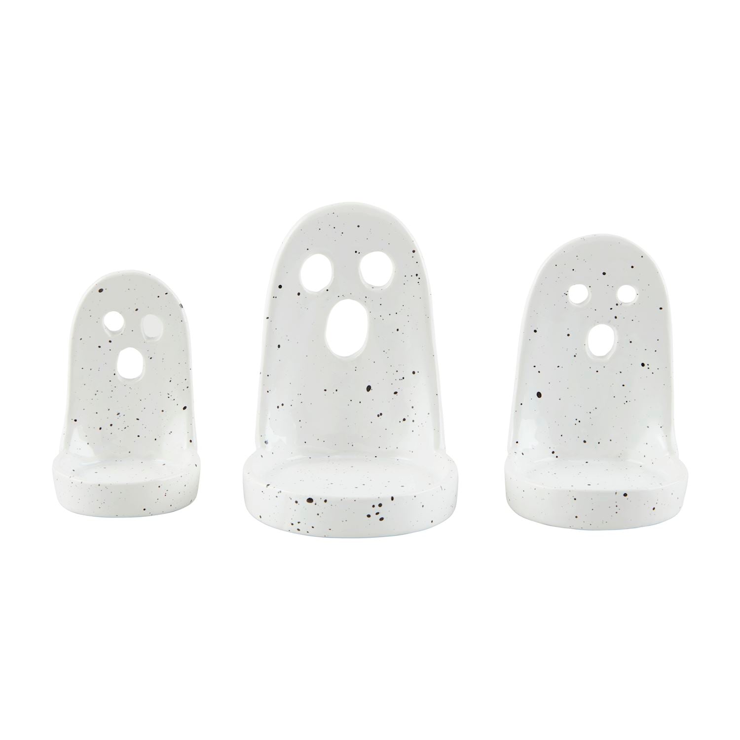 A set of three white ceramic tea light holders with a ghost face design.
