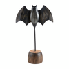 Four decorative items for Halloween, including a bat, a ghost, a pumpkin, and a pumpkin with a face painted in the style of a ghost.