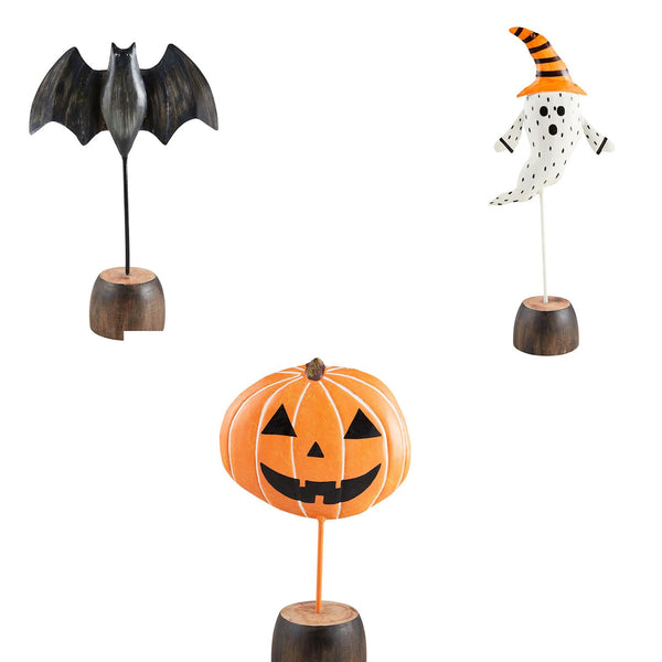 Four decorative items for Halloween, including a bat, a ghost, a pumpkin, and a pumpkin with a face painted in the style of a ghost.