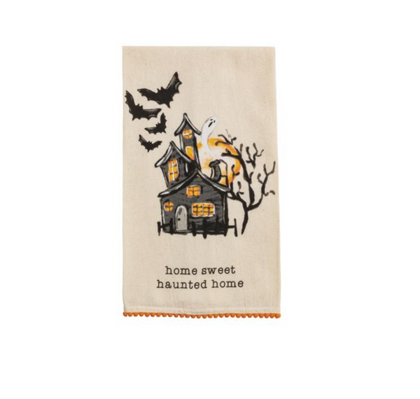 Halloween-themed towel with haunted house design and text on a white background