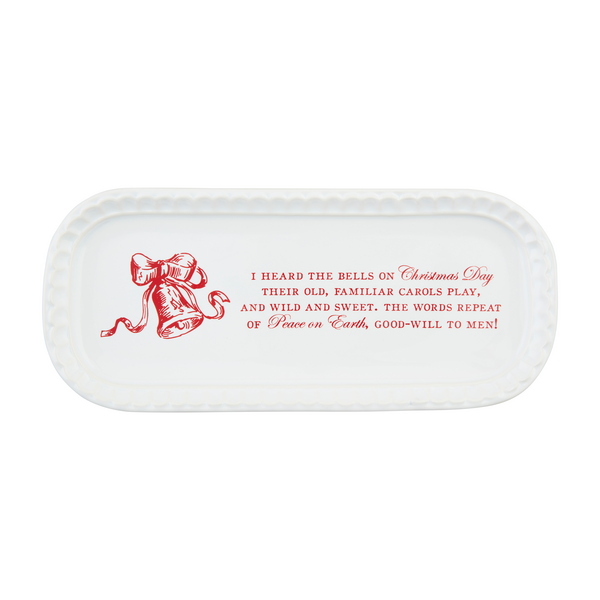 A white stoneware plate with a textured rim, featuring a red bow design and Christmas-themed text including 'I heard the bells on Christmas Day' and other festive phrases.