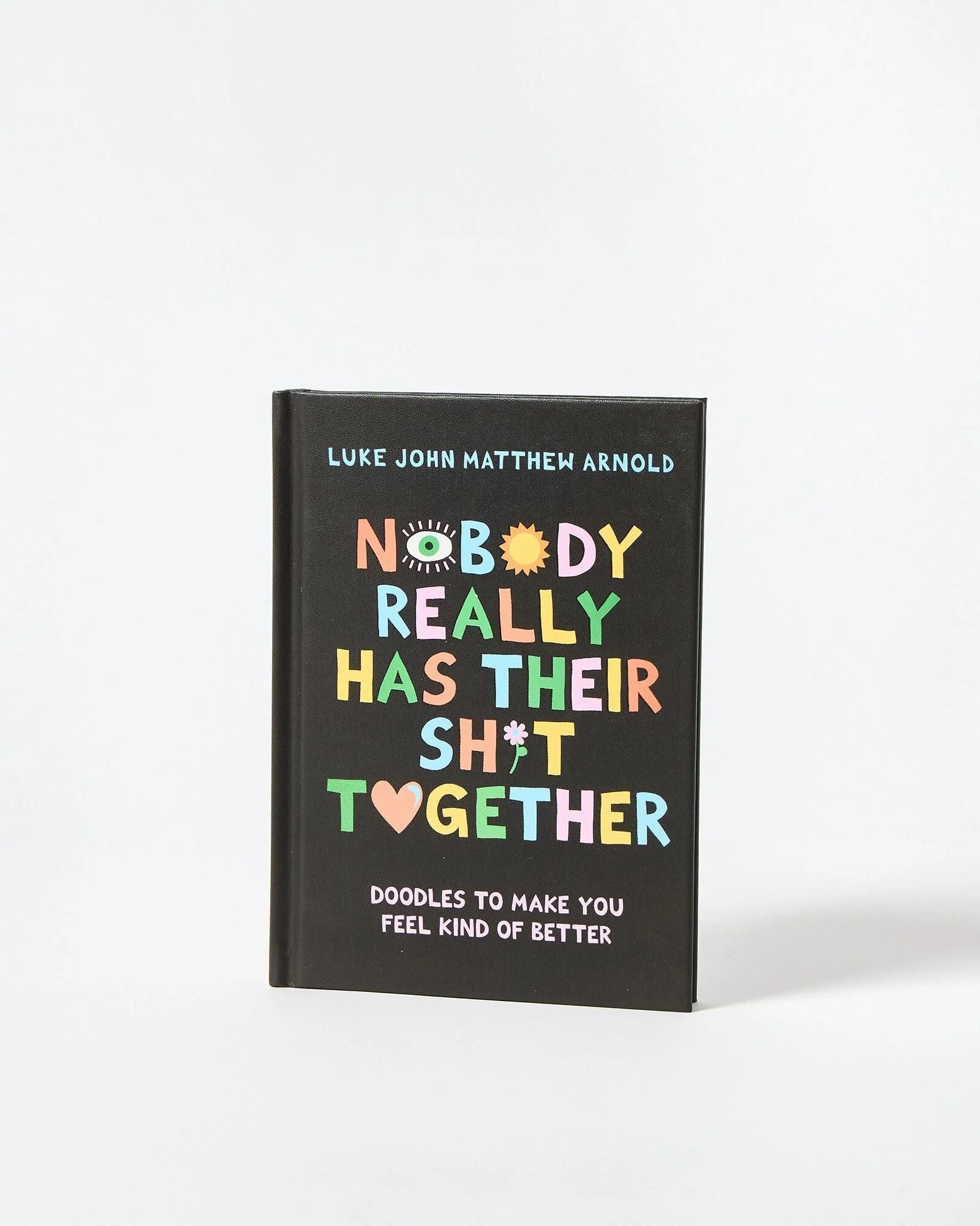 Book titled 'Nobody Really Has Their Sh*t Together' with colorful text on a black background