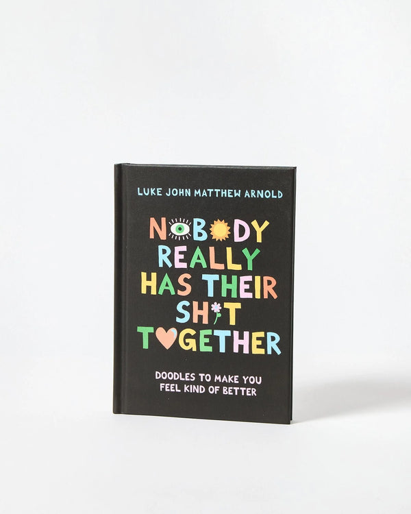 Book titled 'Nobody Really Has Their Sh*t Together' with colorful text on a black background