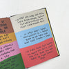 Open book with colorful text on a white background
