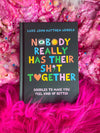 Book titled 'Nobody Really Has Their Sh*t Together' by Luke John Matthew Arnold on a pink textured background