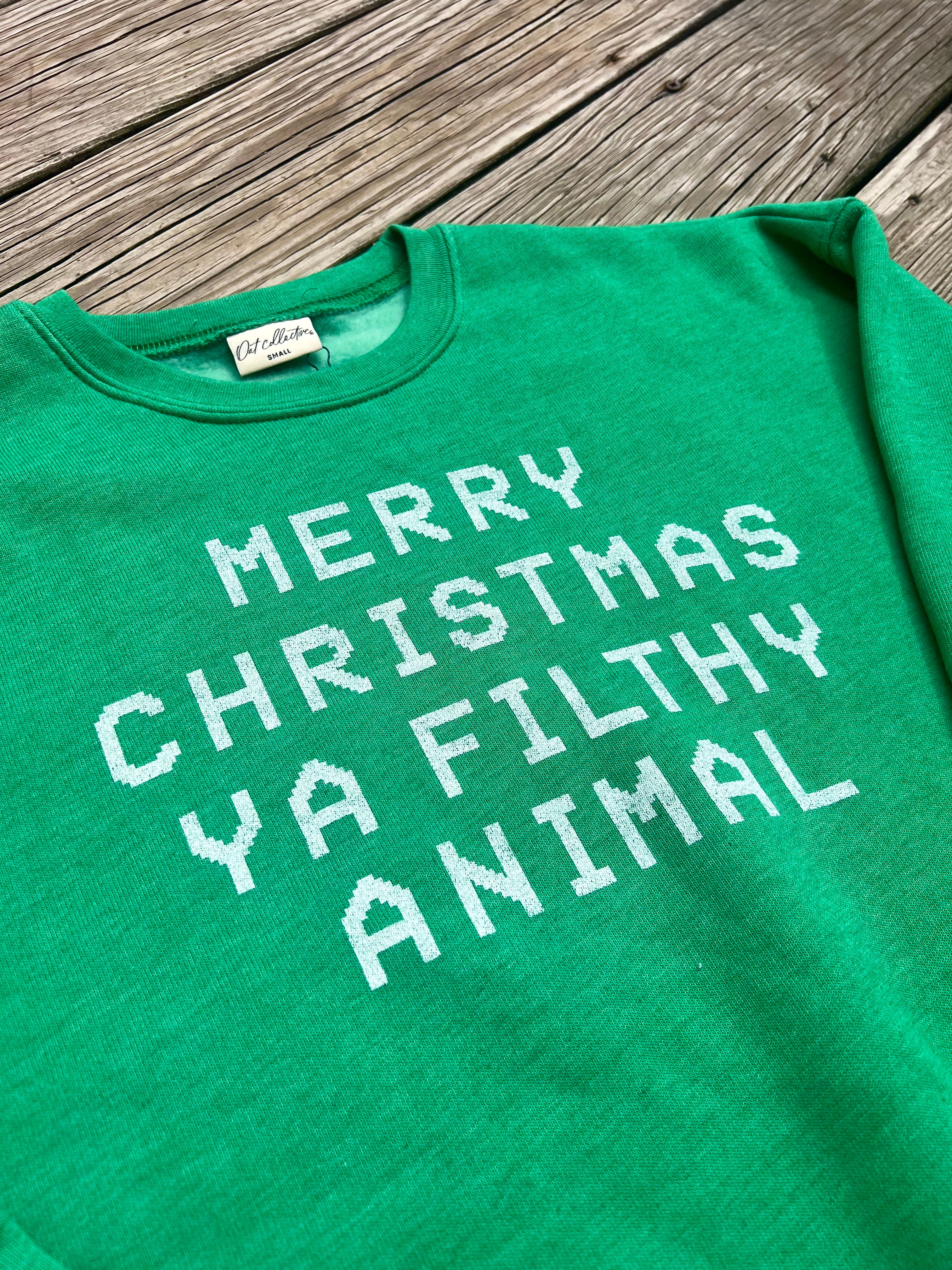 Green t-shirt with white text on a wooden surface