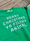 Green t-shirt with white text on a wooden surface