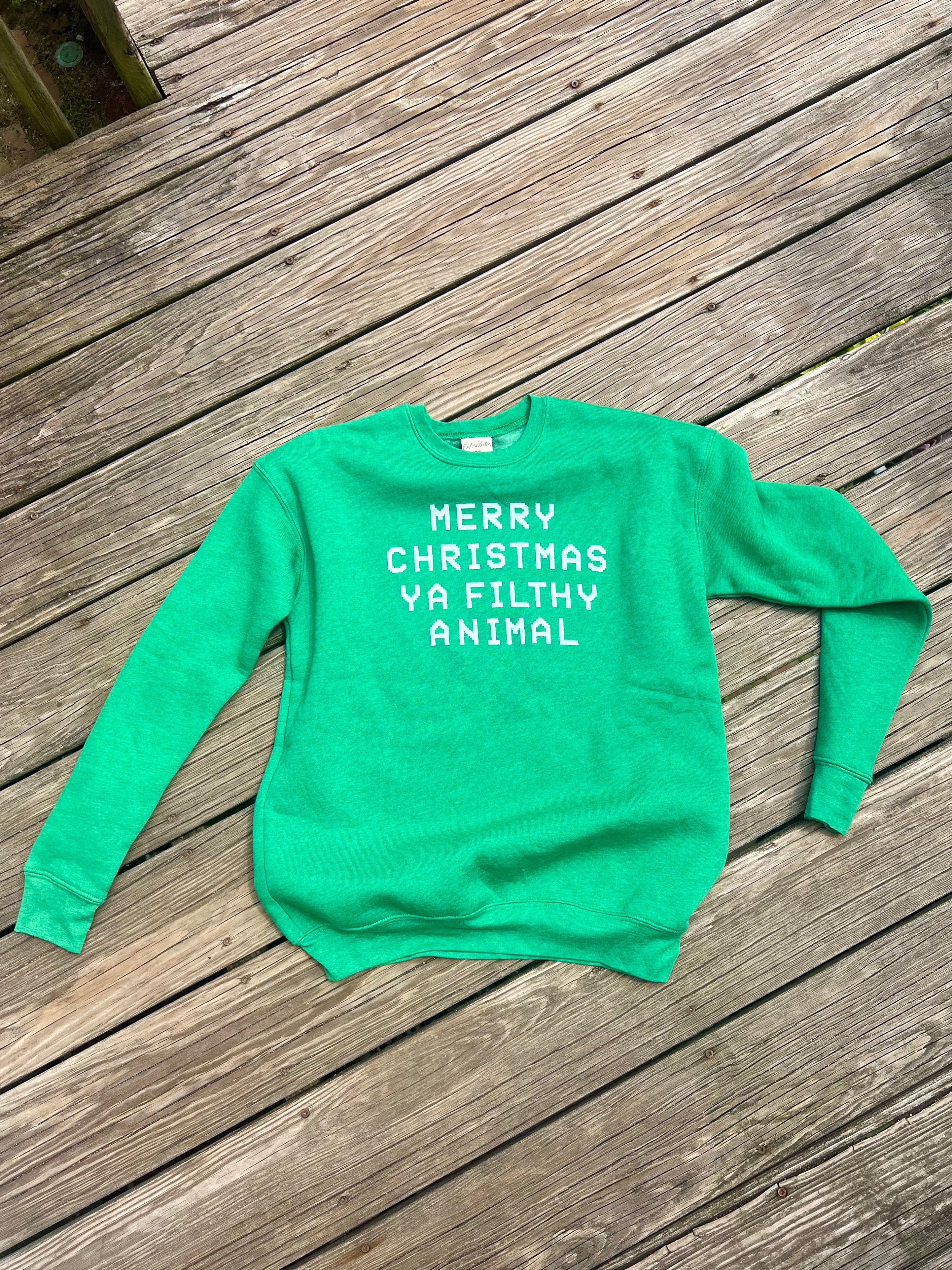 Green sweatshirt with text on a wooden surface