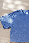 Blue t-shirt on a wooden floor