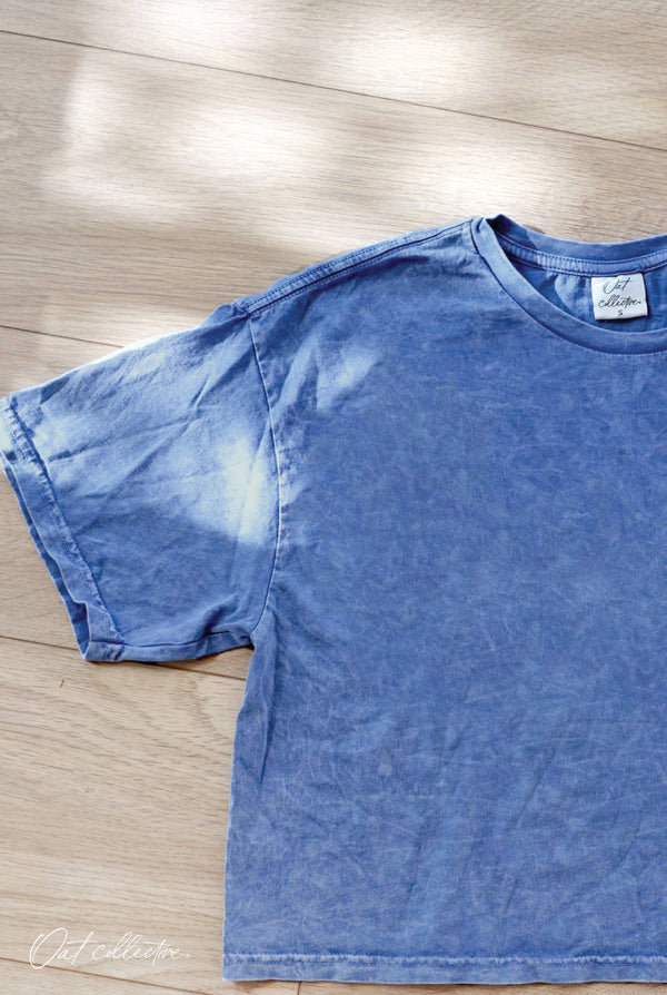Blue t-shirt on a wooden floor