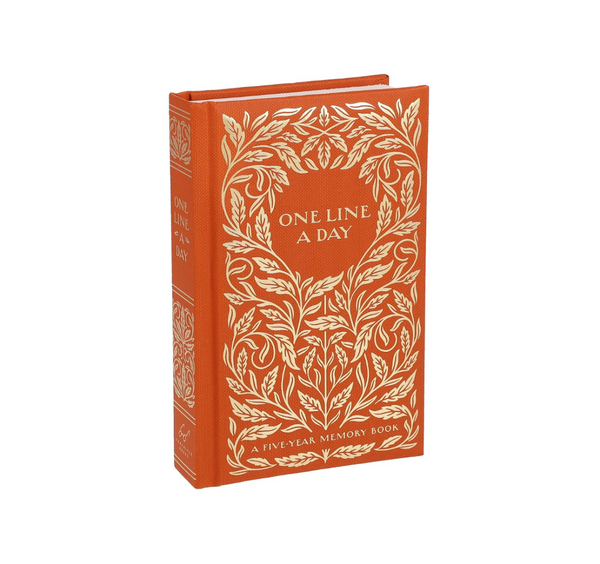Brown book with gold leaf design and 'One Line A Day' text on a white background