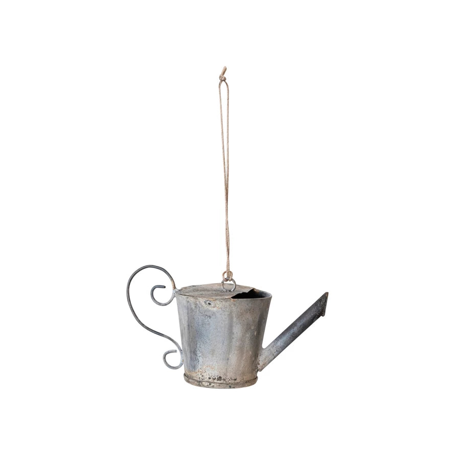 A distressed zinc finish metal watering can ornament with a hanging loop, designed for holiday decoration.