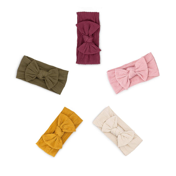 Set of five colorful headbands with large bows on a white background