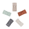 Set of five knotted headbands in different colors on a white background