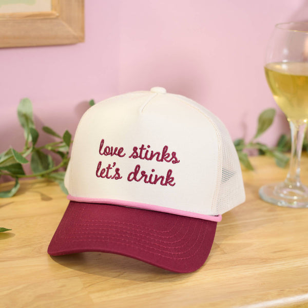 LOVE STINKS LET'S DRINK TRUCKER HAT