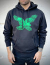 Person wearing a dark hoodie with a green eagle design on a plain background