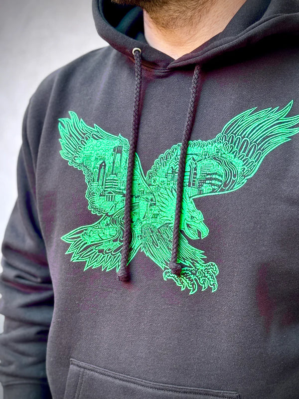 Gray hoodie with green eagle design on a neutral background