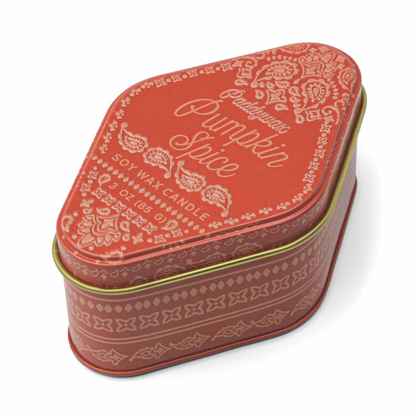 Pumpkin spice candle tin with decorative design on a white background
