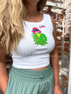 Person wearing a white tank top with a colorful Phanatic graphic against a brick wall.