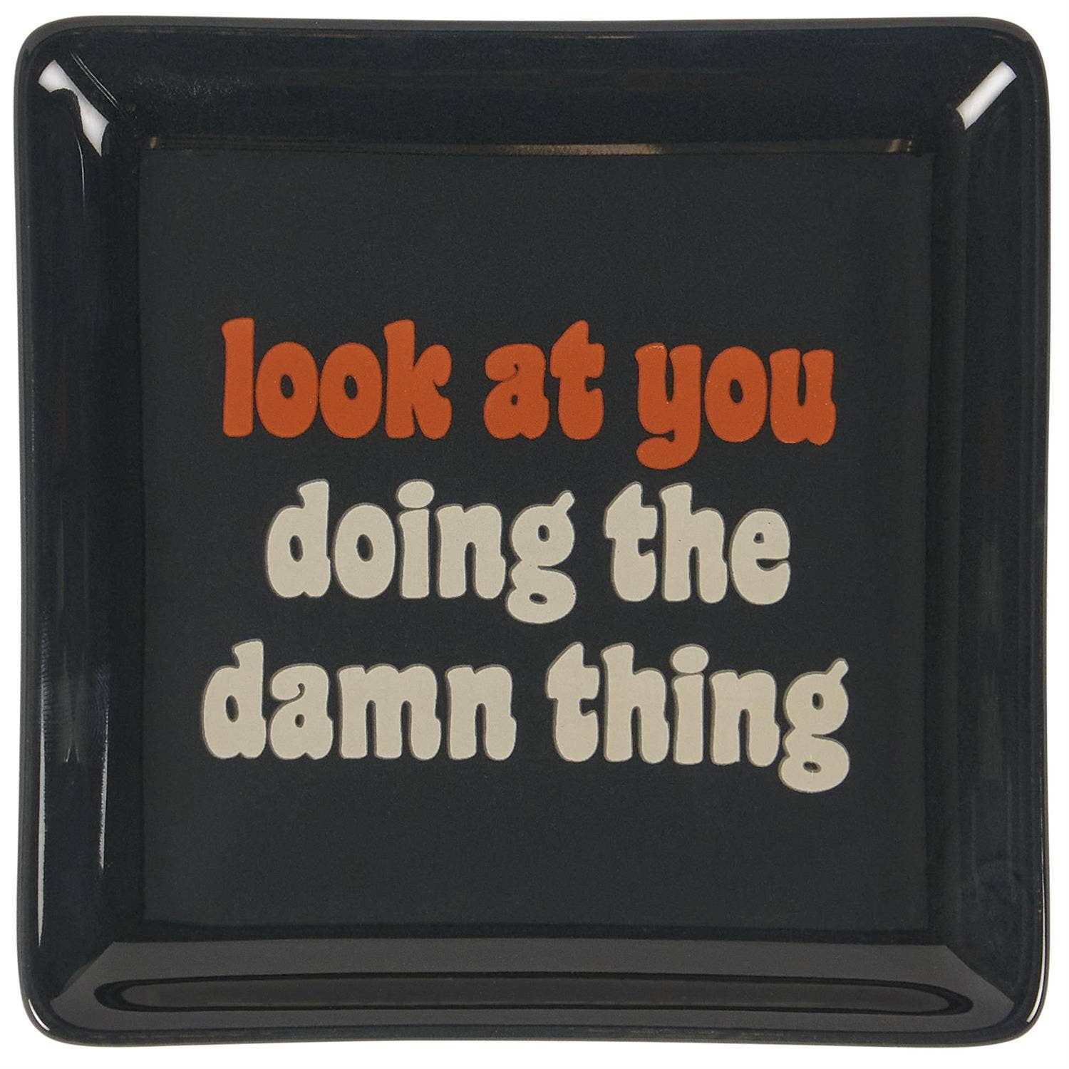 Black square plate with red and white text on a white background