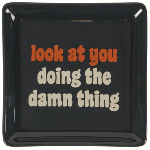 Black square plate with red and white text on a white background