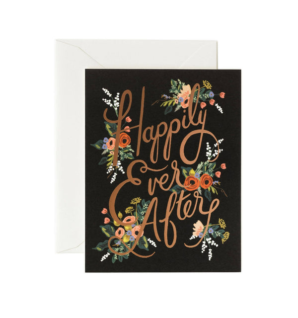 A greeting card with a natural white cover, printed floral design, and the text 'Happily Ever After' in metallic gold foil.