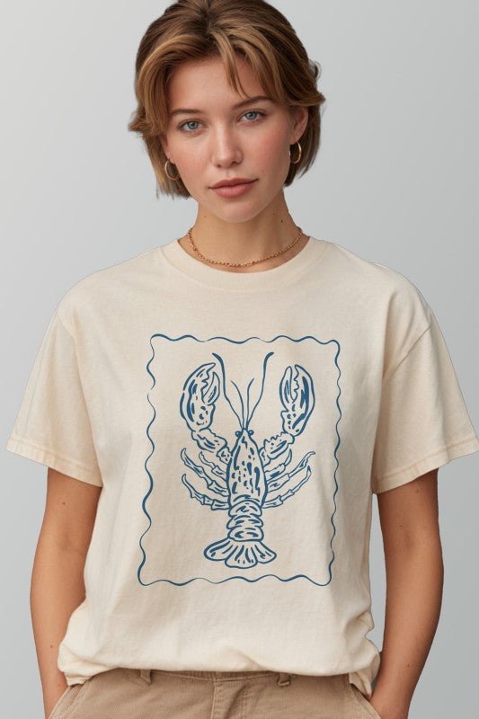 Person wearing a beige t-shirt with a blue lobster design on a plain background
